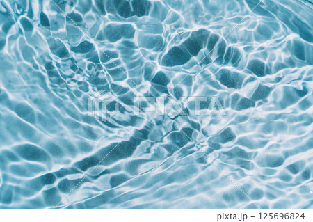 Blue water background with waves and glare 125696824