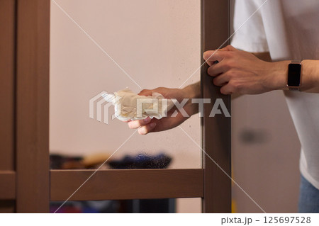 Meticulously Cleaning the Glass Surface with Care and Attention to Detail and Efficiency 125697528