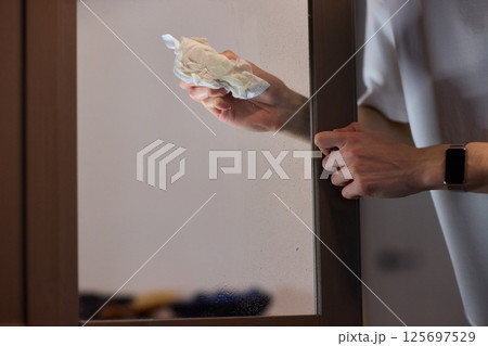 Meticulously Cleaning the Glass Surface with Care and Attention to Detail and Efficiency 125697529