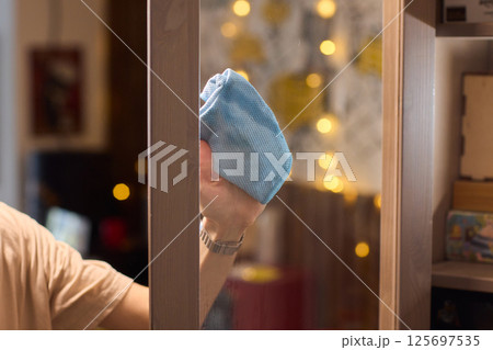 Meticulously Cleaning the Glass Surface with Care and Attention to Detail and Efficiency Meticulously Cleaning the Glass Surface with Care and Attention to Detail and Efficiency 125697535
