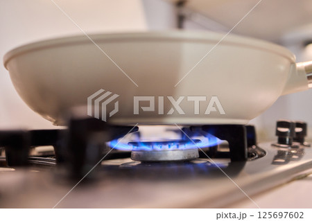 Bright Blue Flame Emanating from a Gas Burner in a Kitchen Setting Suitable for Cooking Bright Blue Flame Emanating from a Gas Burner in a Kitchen Setting Suitable for Cooking 125697602