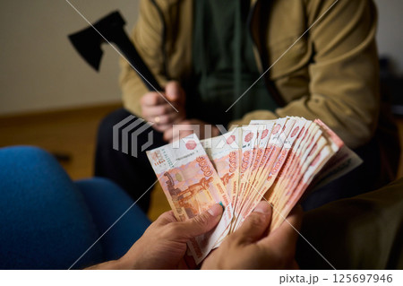 A Cash Transaction That Carries Unsettling and Uneasy Undertones of Tension and Anxiety 125697946
