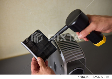 How To Effectively Clean a Portable Air Purifier Filter Utilizing a Vacuum Cleaning Tool 125697956