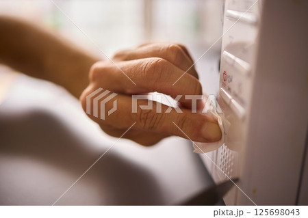 A person is meticulously hand cleaning a surface using a cloth in a bright and inviting environment A person is meticulously hand cleaning a surface using a cloth in a bright and inviting environment 125698043