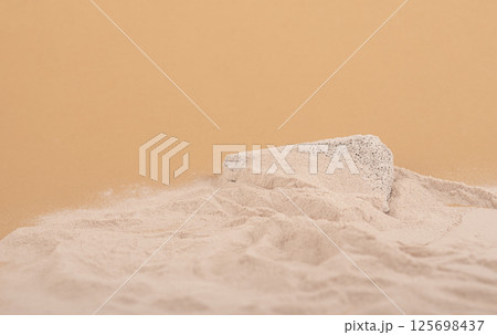 beach sand with copy space and grey concrete stone platform podium for cosmetics or products. on beige background. beach sand with copy space and grey concrete stone platform podium for cosmetics or products. on beige background. 125698437
