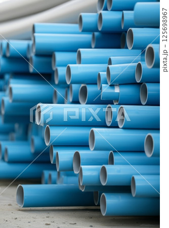 Pvc pipes stacked at construction site material storage area 125698967
