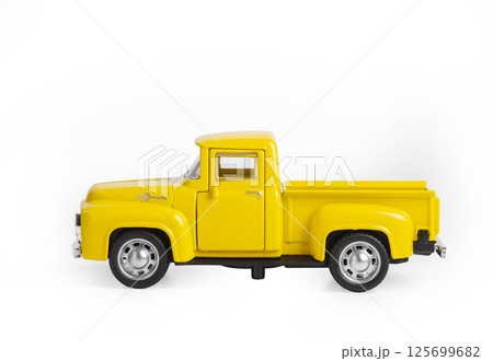 yellow iron toy car the truck isolated on a white background yellow iron toy car the truck isolated on a white background 125699682