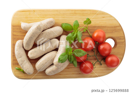Bavarian white sausages with basil and tomatoes isolated on a white background. 125699888
