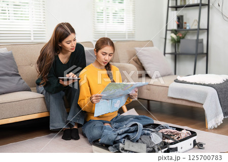 Travel planning and packing for a trip with friends 125700783