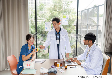 Doctor sharing medication details with a nurse in a meeting Doctor sharing medication details with a nurse in a meeting 125700802