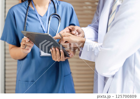 Doctor and nurse reviewing medical data in a collaborative environment Doctor and nurse reviewing medical data in a collaborative environment 125700809