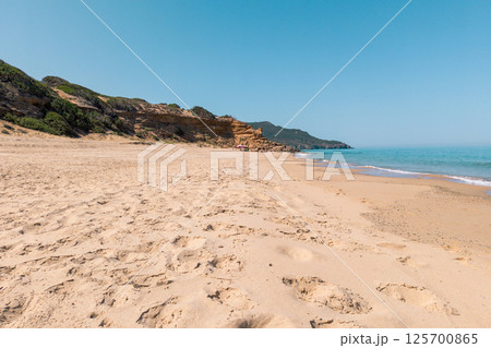 Sandy Beach with Cliffs and Clear Blue Sea Sandy Beach with Cliffs and Clear Blue Sea 125700865