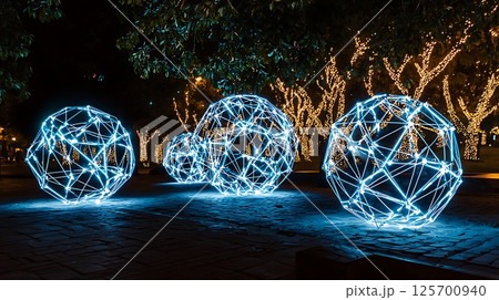 Three glowing spheres are lit up in the dark, creating a sense of wonder 125700940