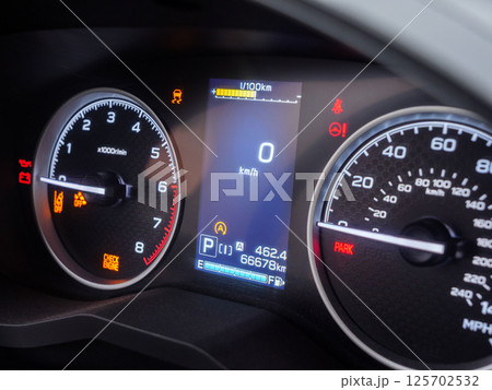 Close up view of a car dashboard displaying warning lights, zero speed, and other information Close up view of a car dashboard displaying warning lights, zero speed, and other information 125702532
