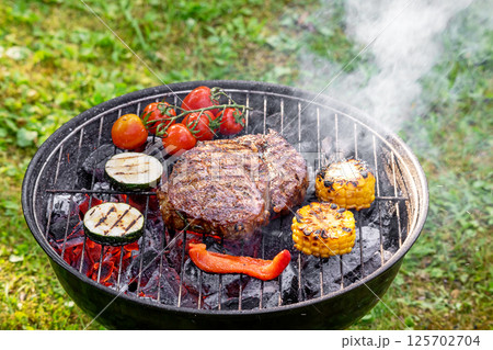 beef steak and vegetables on grill 125702704