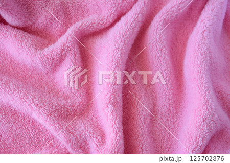 Knitted pink texture fabric. Textile cloth background. Knitted pink texture fabric. Textile cloth background. 125702876