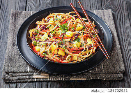 Thai Mango Noodle Veggie Salad in a bowl Thai Mango Noodle Veggie Salad in a bowl 125702921
