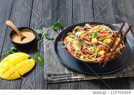 Thai Mango Noodle Veggie Salad in a bowl Thai Mango Noodle Veggie Salad in a bowl 125702924