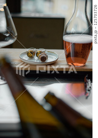Decanter for sparkling wine on the table, Champagne tasting, Wine glasses, reflections, rose wine 125703726