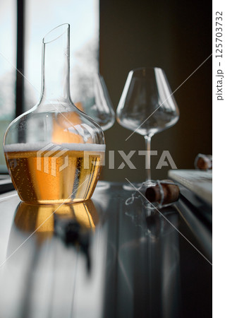Decanter for sparkling wine on the table, Champagne tasting, Wine glasses, reflections, rose wine 125703732