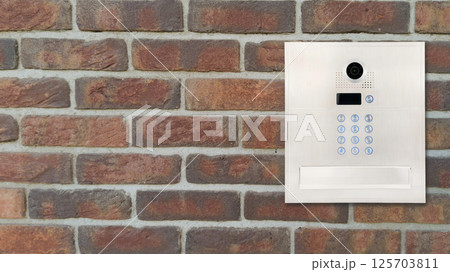Modern Intercom Panel on Brick Wall 125703811