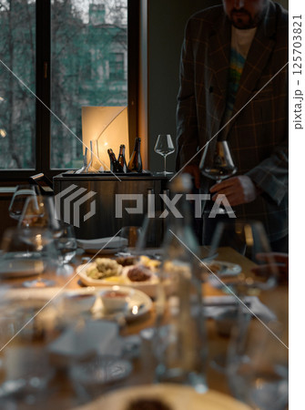 Several bottles of champagne are cooled in a niche with ice in the restaurant, local lighting, wine cabinet, decanters for sparkling wine Several bottles of champagne are cooled in a niche with ice in the restaurant, local lighting, wine cabinet, decanters for sparkling wine 125703821