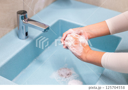 Hand washing with soap and water at sink Hand washing with soap and water at sink 125704558