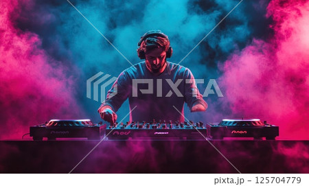 DJ Mixing Music in a Colorful Smoke-Filled Club 125704779