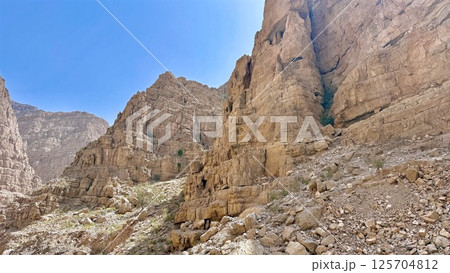 Massive golden hill composed of fractured sediment blocks forms step-like shapes, ancient wind-sculpted textures offer immersive destination for eco-travelers, geologists, and desert explorers. 125704812
