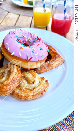 Sweet selection highlights playful donut with pastel frosting, golden pastries shimmer with soft texture, joyful breakfast scene evokes light-hearted indulgence and morning delight Sweet selection Sweet selection highlights playful donut with pastel frosting, golden pastries shimmer with soft texture, joyful breakfast scene evokes light-hearted indulgence and morning delight Sweet selection 125704841