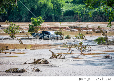 Truck stuck in mud after flooding by Kok river in Chiang Rai province of Thailand. 125710958