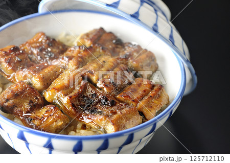 熱々うな丼を黒背景で撮影 125712110