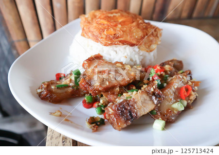 stir fried pork or deep fried pork , fried pork or crispy pork and rice with fried egg or sunny side up egg or pork and rice stir fried pork or deep fried pork , fried pork or crispy pork and rice with fried egg or sunny side up egg or pork and rice 125713424