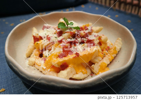 fresh cheesy fries in dish in restaurant 125713957