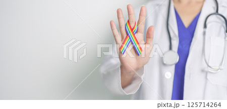 Doctor with LGBTQ Rainbow ribbon for Support Lesbian, Gay, Bisexual, Transgender and Queer community and happy Pride month concept Doctor with LGBTQ Rainbow ribbon for Support Lesbian, Gay, Bisexual, Transgender and Queer community and happy Pride month concept 125714264