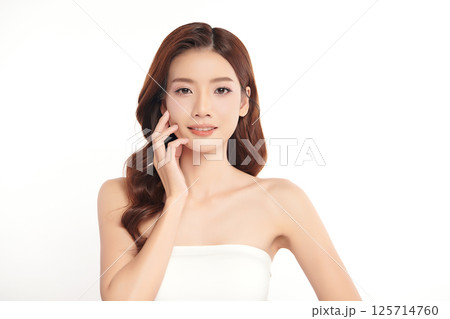 A beautiful young Asian woman with clean, fresh skin against a white background. Skincare, facial treatment, cosmetology, beauty, and spa. An elegant portrait of an Asian woman. 125714760