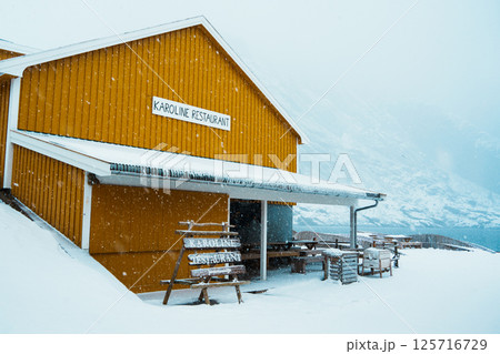 A colorful village by Snowy Fjord in Winter. Nusfjord, Lofoten. A colorful village by Snowy Fjord in Winter. Nusfjord, Lofoten. 125716729