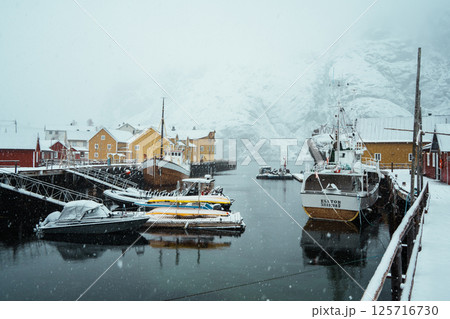 A colorful village by Snowy Fjord in Winter. Nusfjord, Lofoten. 125716730