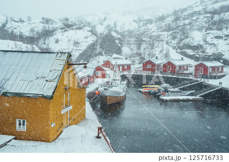 Nusfjord Harbor with Colorful Cabins and Boat. Lofoten. 125716733