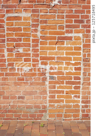 Reddish brick wall with the outline of a bricked-up window and a bricked-up door, bricks, background, Germany, Europe 125718495