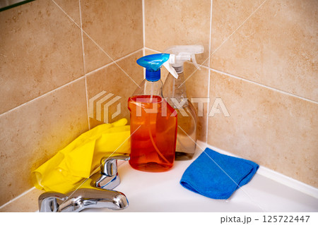 Spray detergents, cleaning bathroom tube and water tap, yellow gloves and fibber cloth Spray detergents, cleaning bathroom tube and water tap, yellow gloves and fibber cloth 125722447