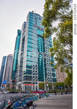 Shanghai, China - Modern business district in Pudong featuring Yestar plastic surgery clinic in a striking turquoise-glass skyscraper with "M" logo at Metrobank Plaza 125722626