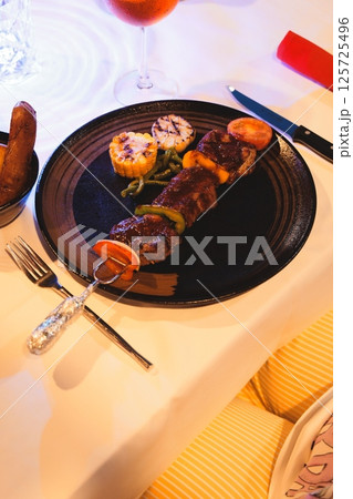 Delicious Grilled Meat Skewers Accompanied by Colorful Vegetables and Savory Sides 125725496