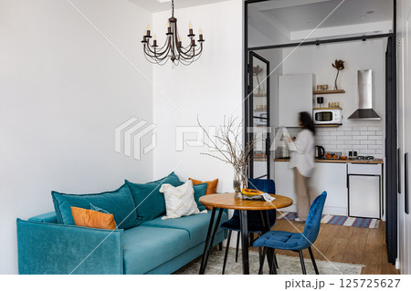 A Modern and Cozy Living Space That Features Stylish Decor and a Beautiful Kitchen View A Modern and Cozy Living Space That Features Stylish Decor and a Beautiful Kitchen View 125725627