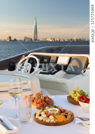 Experience Luxurious Yacht Dining Complete with Beautiful Scenic City Views and Ambiance Experience Luxurious Yacht Dining Complete with Beautiful Scenic City Views and Ambiance 125725869