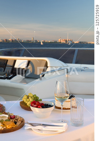 Enjoy an Elegant Dining Experience on a Luxurious Yacht during a Stunning Sunset Enjoy an Elegant Dining Experience on a Luxurious Yacht during a Stunning Sunset 125725919