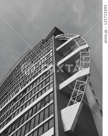 Modern Architectural Design featuring a Unique Curved Facade presented in Black and White 125725995