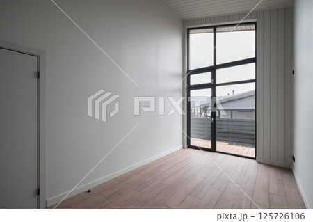 A modern interior space that features large windows allowing for an abundance of natural light 125726106