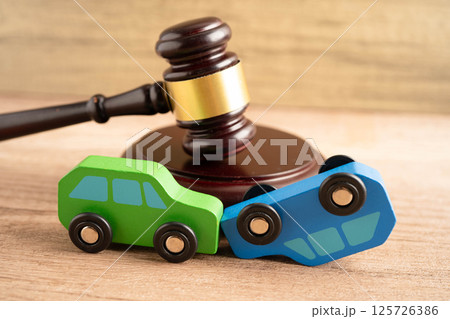 Car accident lawsuit and insurance, Judge hammer with car model. 125726386