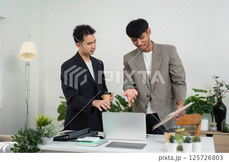 Business Collaboration and Teamwork. Two professionals discussing ideas in a modern office setting. Business Collaboration and Teamwork. Two professionals discussing ideas in a modern office setting. 125726803